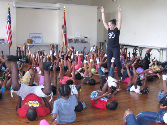 Instructor leading a yoga class for kids