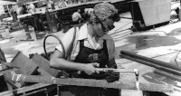 Woman wearing goggles welding metal, 1943